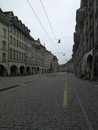 Street amidst buildings against sky in city