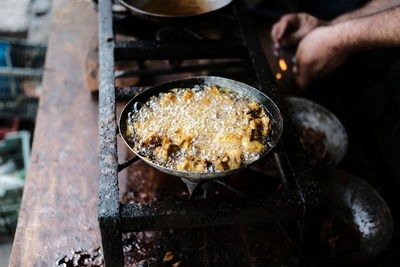 Midsection of person preparing food in kitchen