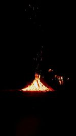 Close-up of bonfire against clear sky at night