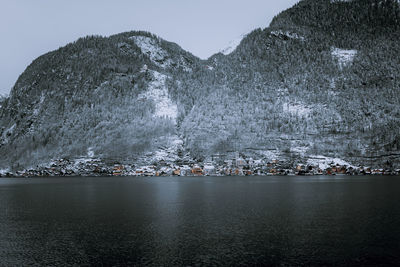 Scenic view of historic town against mountain during winter