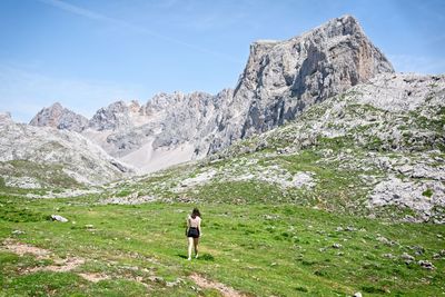 A young woman goes hiking in the mountains