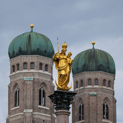 Low angle view of statue against building