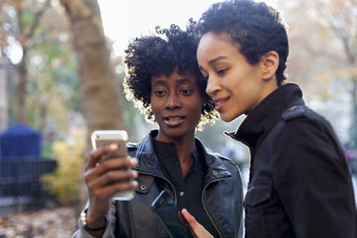 Young women checking their smart phones