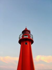 Lighthouse against clear sky during sunset