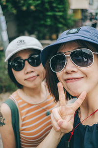 Portrait of woman wearing sunglasses while standing outdoors