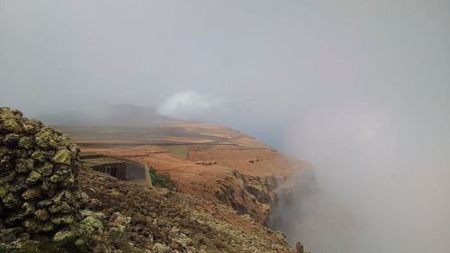 Scenic view of mountains in foggy weather