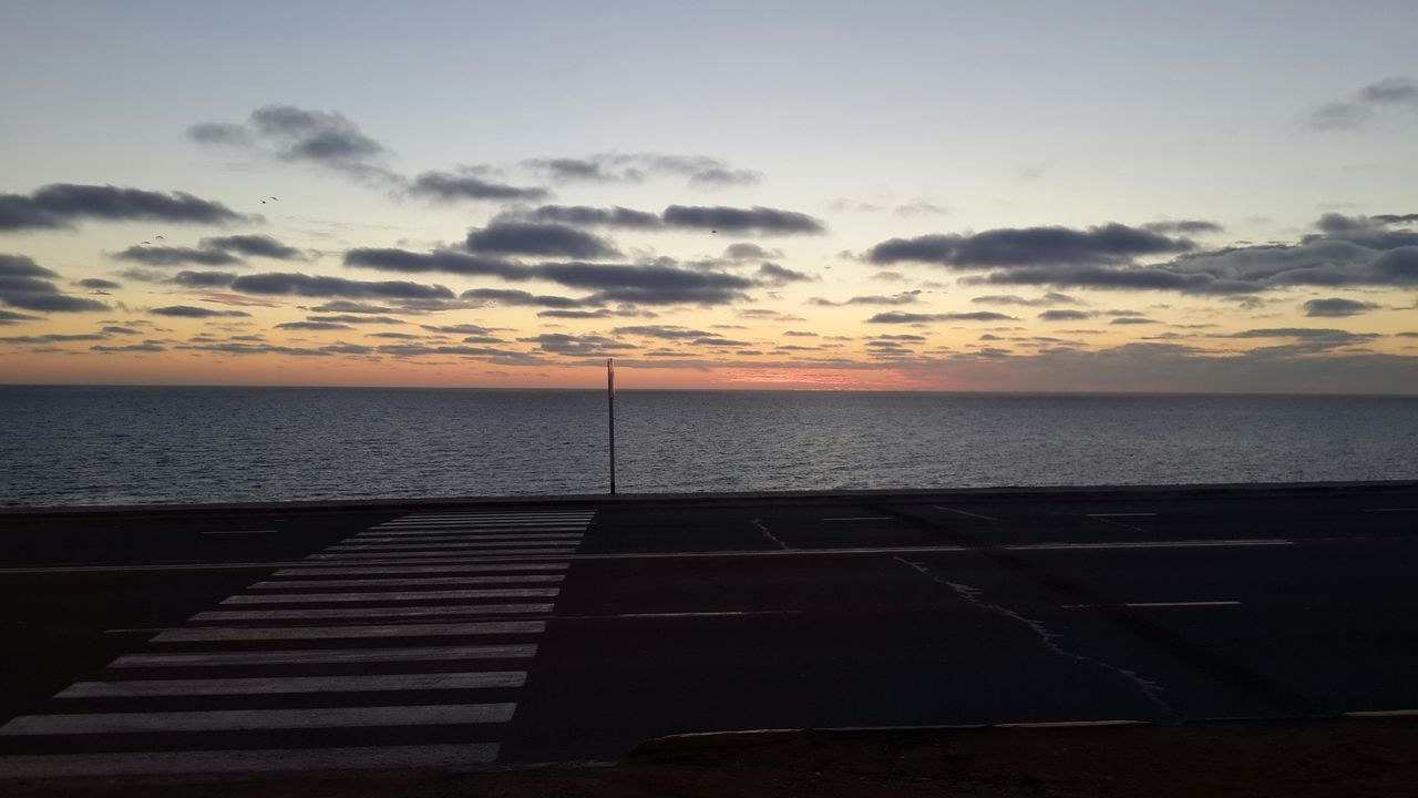 sea, horizon over water, sunset, water, sky, scenics, tranquil scene, tranquility, beauty in nature, cloud - sky, nature, orange color, railing, idyllic, beach, cloud, pier, shore, outdoors, silhouette