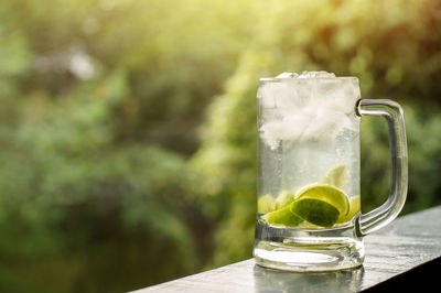 Cocktail on railing against trees