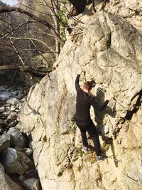 High angle view of man climbing on rock formation