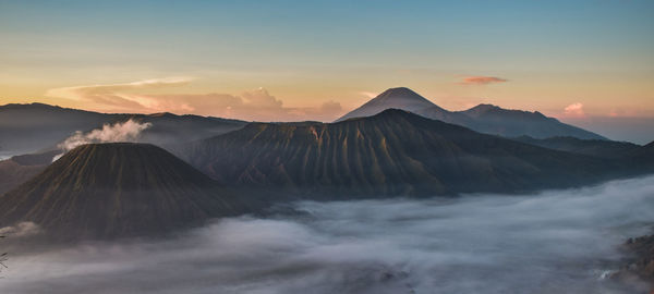 Panoramic view of volcanic landscape against sky during sunset
