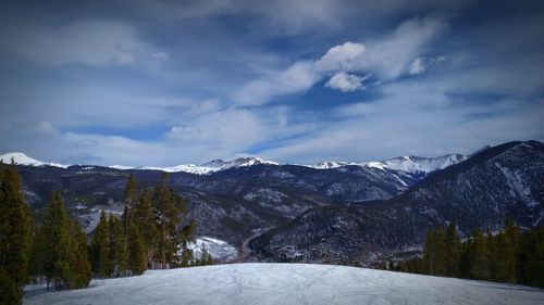 Scenic view of snow covered mountains against sky