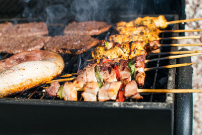 Chickens cooking on barbecue grill