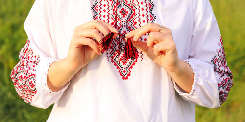 Midsection of woman holding hands