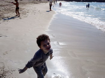 High angle portrait of boy playing at beach