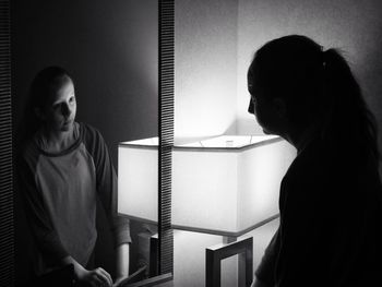 Reflection of girl on mirror in darkroom