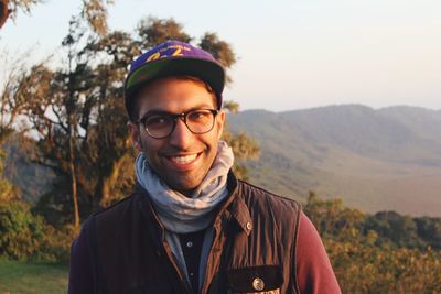 Portrait of young man standing on mountain