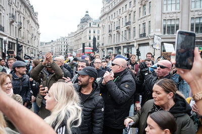 People photographing on street in city