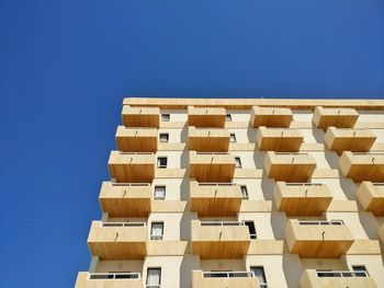 Low angle view of building against blue sky