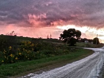 Scenic view of field against cloudy sky