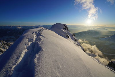 Scenic view of snow landscape against sky during sunset