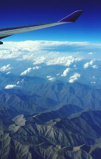 Cropped image of airplane flying over landscape