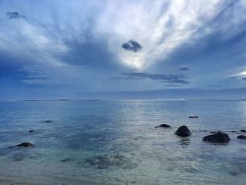 Scenic view of sea against cloudy sky