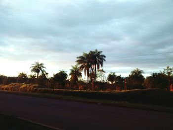 Country road against cloudy sky