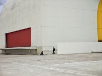 Man walking in front of building