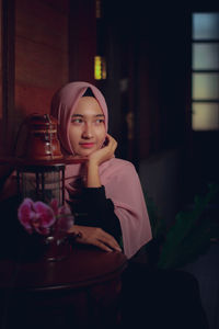 Portrait of a young woman drinking glass