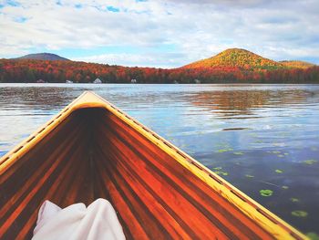 Low section of boat in lake against sky