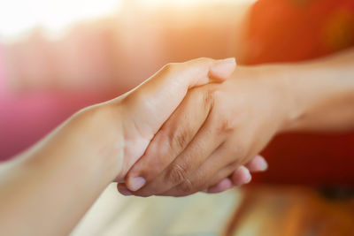 Close-up of people holding hands