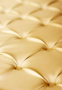 Close-up of gold chesterfield sofa