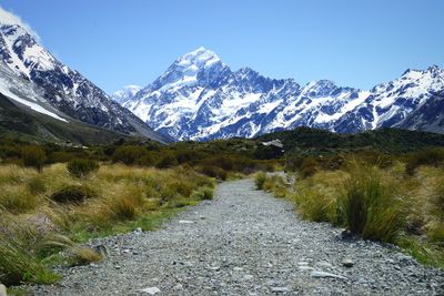 Footpath against snowcapped mountains