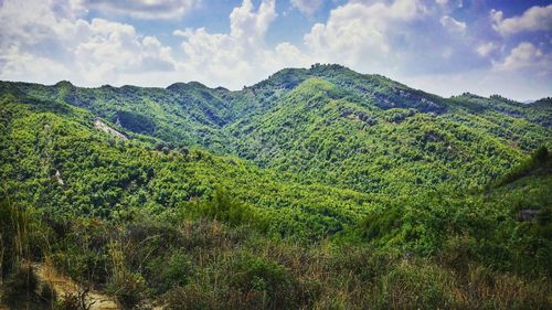 Scenic view of mountains against cloudy sky