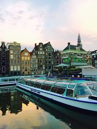 Boats in canal along buildings