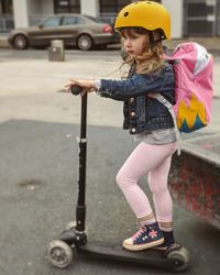 Girl riding scooter  in the city