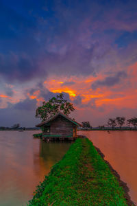 Scenic view of lake against orange sky