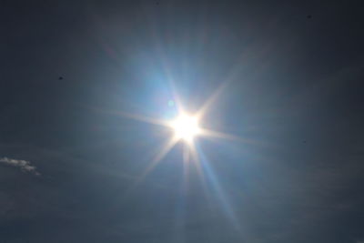 Low angle view of sun shining in sky