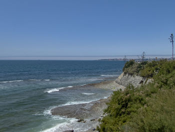 Scenic view of sea against clear blue sky