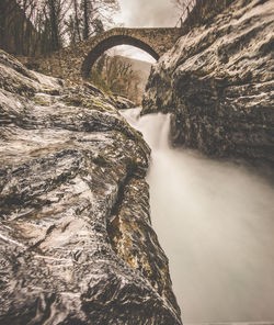 Scenic view of river flowing through rocks