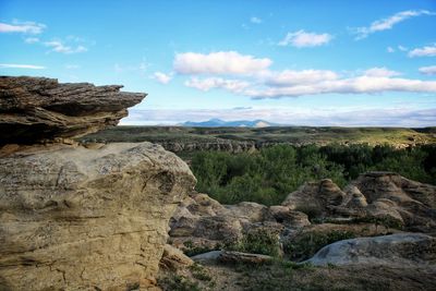 Rock formations on landscape against sky