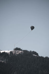 Low angle view of hot air balloons against clear sky