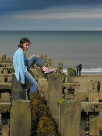 Man standing on beach against sky