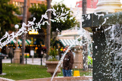 Water splashing on fountain in city