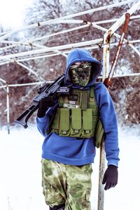Portrait of airsoft player in winter