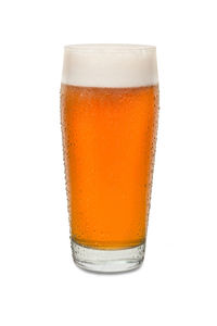 Close-up of beer glass against white background