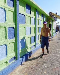 Full length of man skateboarding on wall