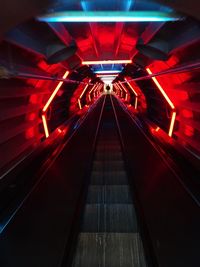 Illuminated escalator at night