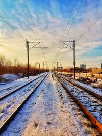 Railroad tracks against sky during winter