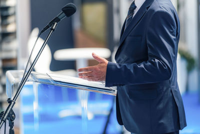 Midsection of businessman using mobile phone
